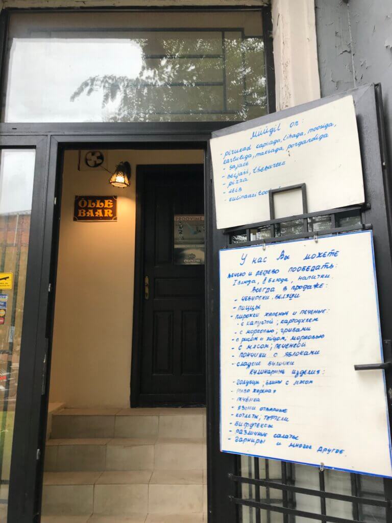 Image for Maria Muuk's Reconfiguring Territories Spring School 2021 Workshop: Obshchenie. The entrance and menu of a culinary shop slash beer bar in Kreenholm, Narva, 2020