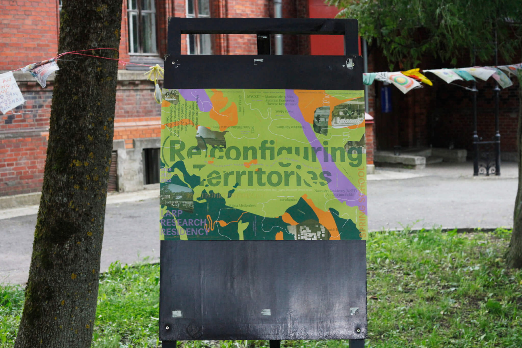 Reconfiguring Territories programme poster in front of Narva Art Residency